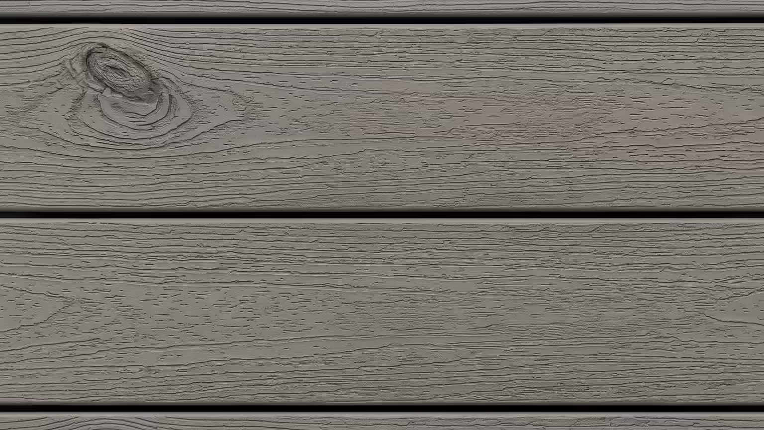 Gray capped composite deck boards with an embossed woodgrain texture and matte finish