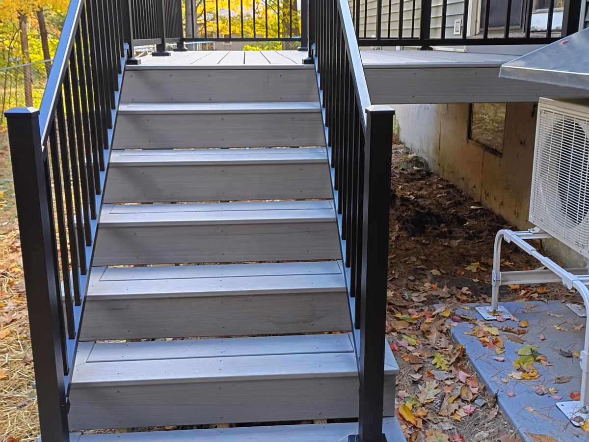 Millstone Trex stair treads with black aluminum railings on the new deck in Milton VT