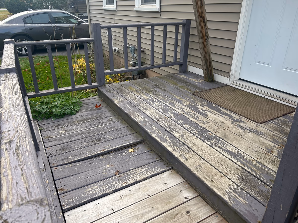 Gray, cupped pressure-treated deck boards on the old deck before it was torn out