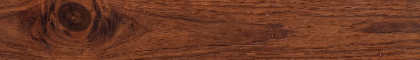 A single deep red-brown mahogany deck board with fine interlocking grain
