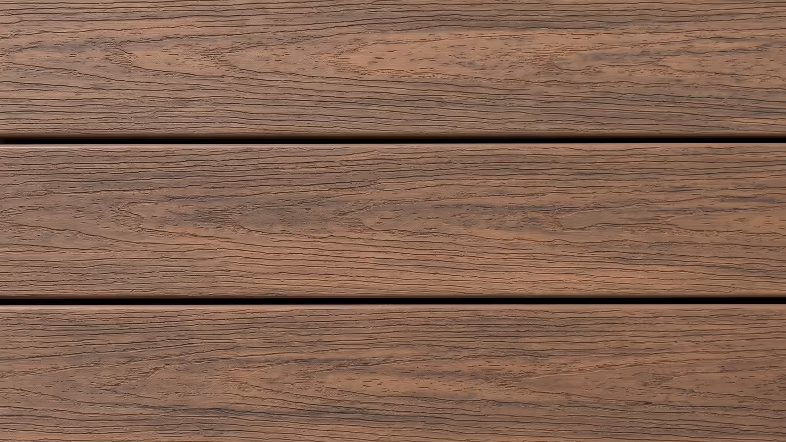 Warm brown PVC deck boards with a smooth streaked grain and no visible knots